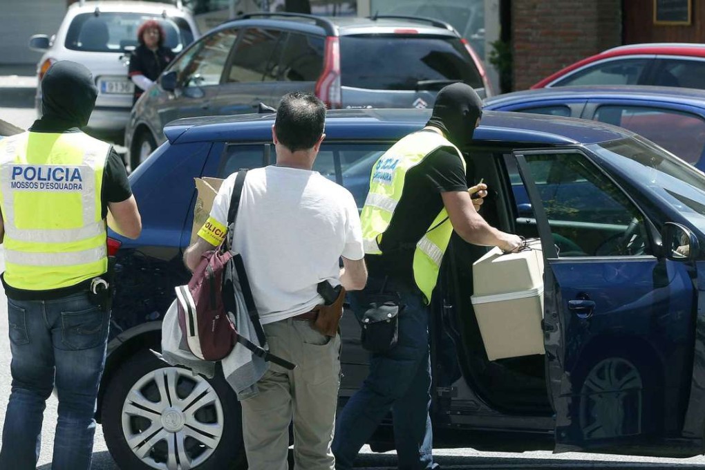 Catalonian police officers confiscate materials belonging to Somali former runner and coach Jama Aden, who was arrested at Arrahona hotel, in Sabadell, Spain, during a doping raid. Photo: EPA
