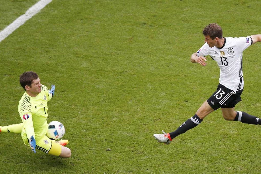 Goalkeeper Michael McGovern of Northern Ireland blocks a shot by Thomas Mueller of Germany. Photo: EPA
