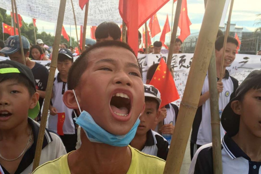 Wukan villagers including schoolchildren take part in a protest march, demanding the release of their village chief Lin Zuluan. Photo: Reuters