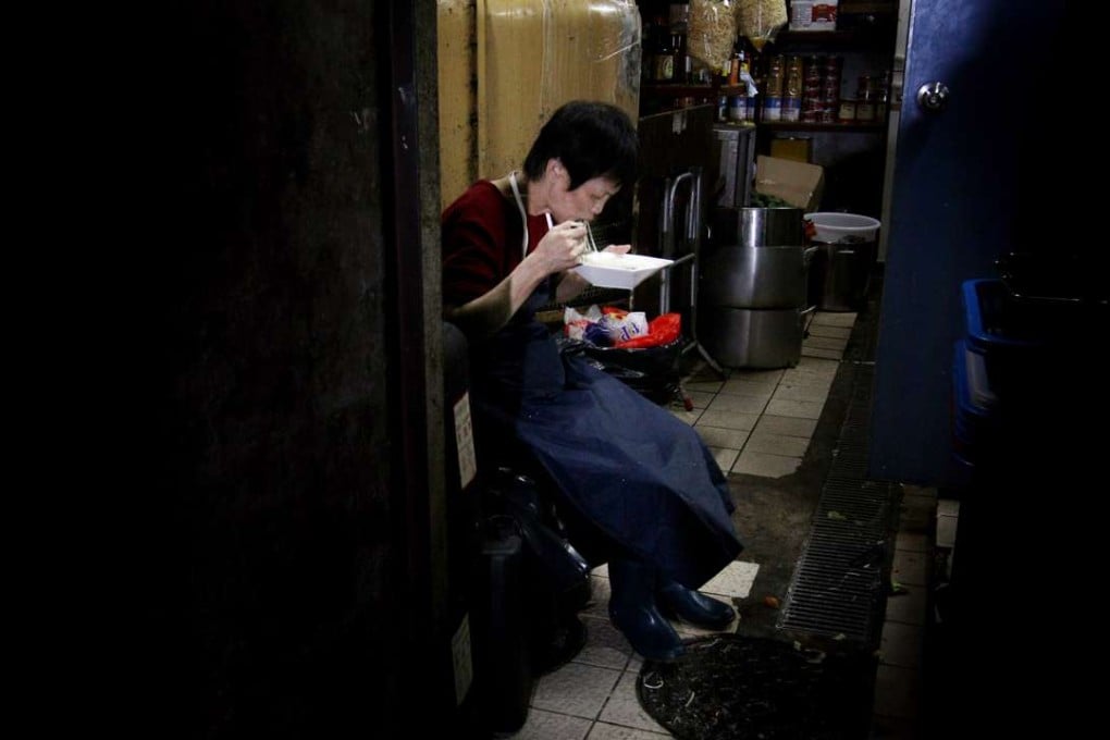 A restaurant worker takes a break from washing dishes to have dinner. Hong Kong needs to create work with career prospects and a respectable salary. Otherwise, we create only a pool of working poor who require government subsidies. Photo: May Tse