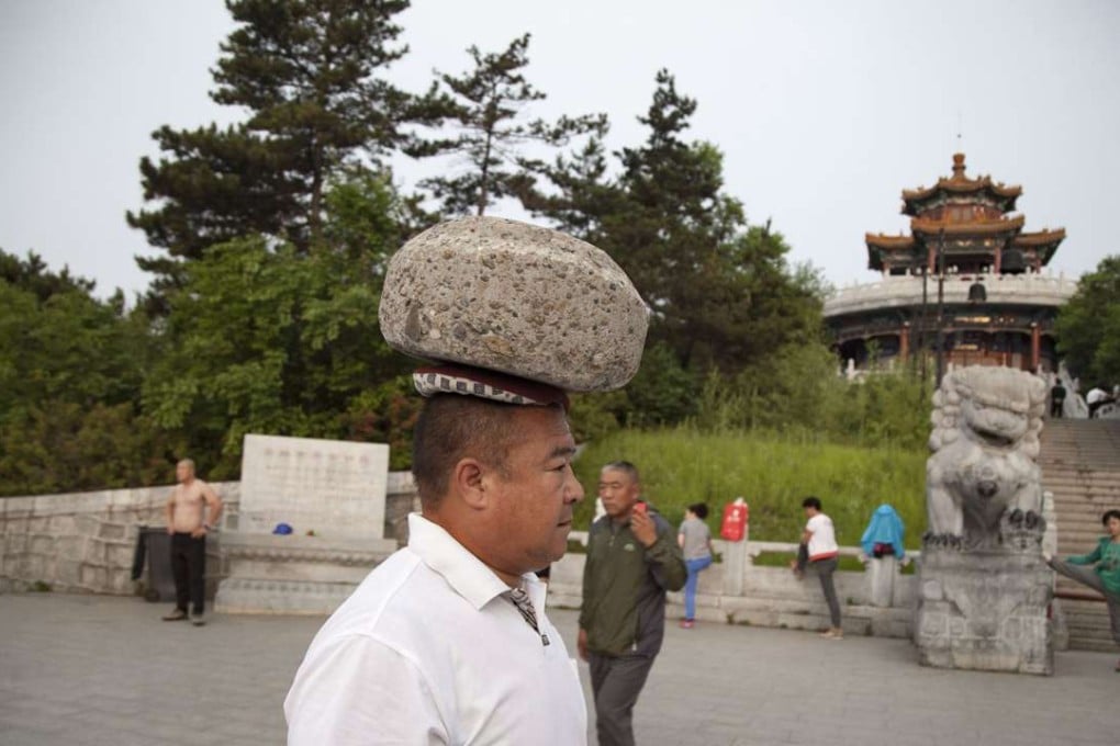 Cong Yan can easily carry the 40kg boulder on his head for a distance of 3,000 metres, mainland media reported. Photo: SCMP Pictures