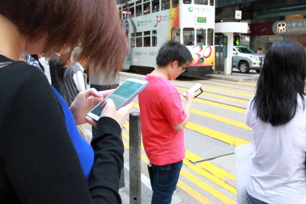 Mobile phone use is ubiquitous on the streets of Hong Kong. Photo: SCMP