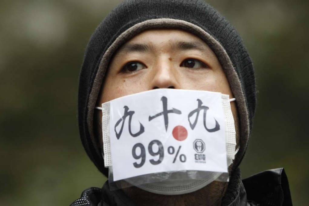 A protester in Tokyo joins a rally in 2011 against bankers, financiers and politicians they accuse of ruining global economies. Today, globalisation is driven not only by trade, finance and people, but also by digital information. Photo: Reuters