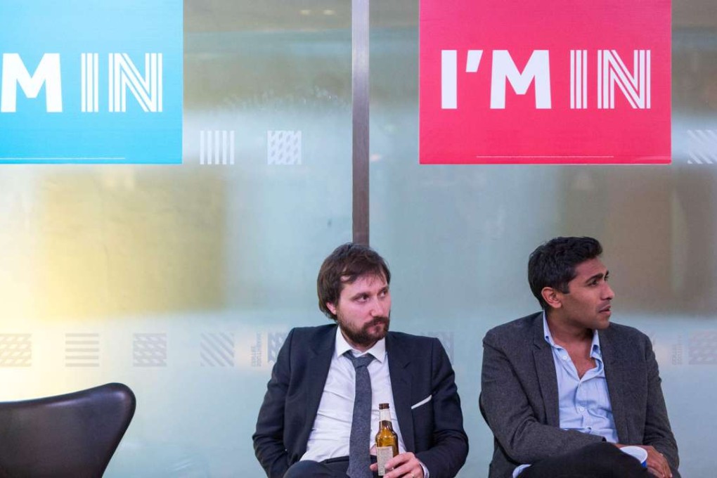 Disconsolate supporters of the Remain campaign watch the results of the EU referendum being announced at the Royal Festival Hall in London early Friday. Photo: AFP