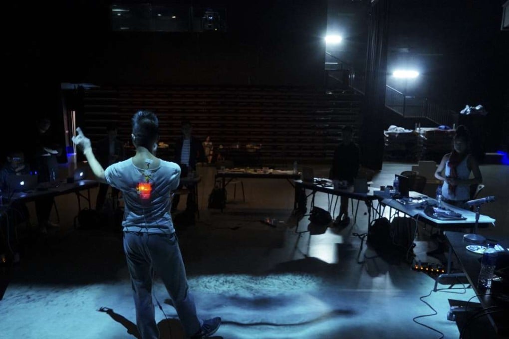 A participant in this week’s Hong Kong workshop with Japanese multimedia artist Hiroaki Umeda wears a body sensor that transmits a representation of his heartbeat which is projected for audiences to see. Photo: Cheung Chi-wai/WKCDA