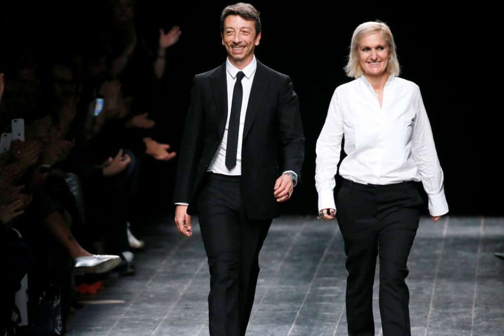 Italian designers Maria Grazia Chiuri and Pier Paolo Piccioli appear at the end of their autumn/winter 2016/2017 women's ready-to-wear collection for fashion house Valentino in Paris. Photo: Reuters