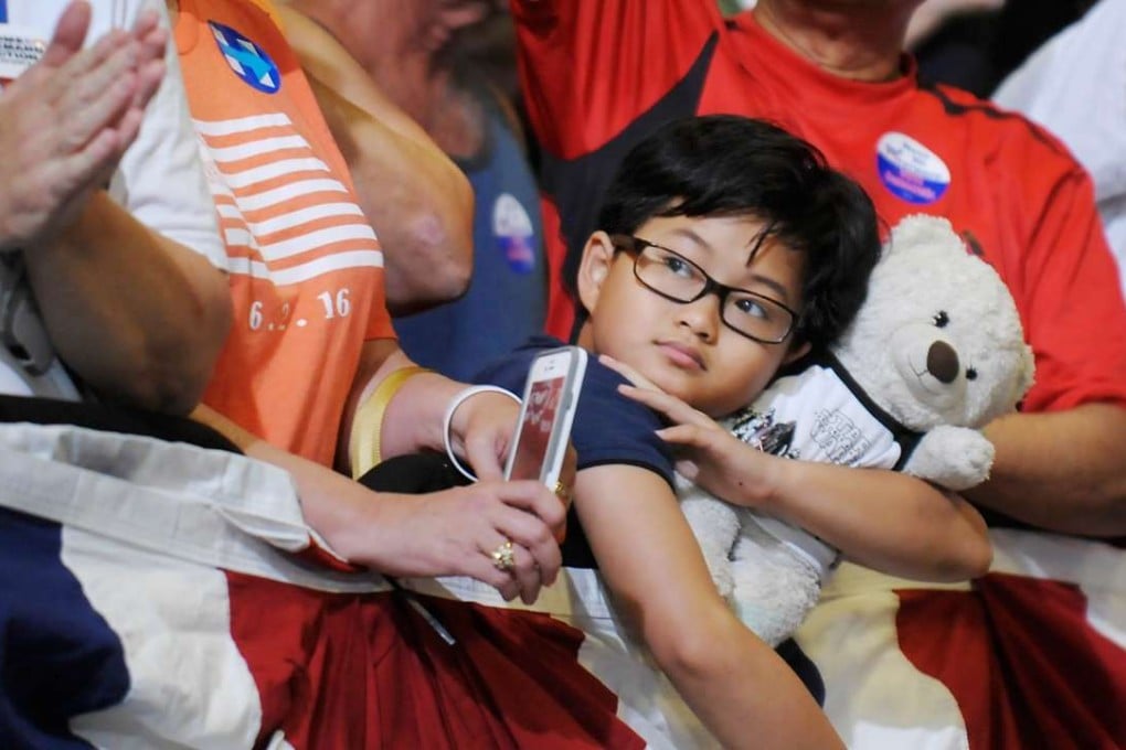 A young supporter awaits the arrival of presumptive Democratic presidential nominee Hillary Clinton at an event in Raleigh, North Carolina. Only 57.5 per cent of the 218 million Americans eligible to vote actually cast their ballot in the 2012 presidential election. Photo: AFP