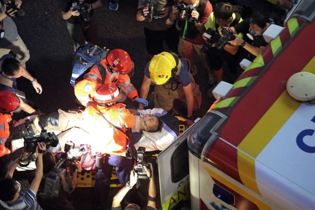 One of the fireman injured battling the Ngau Tau Kok blaze is rushed to hospital. Photo: SCMP Pictures