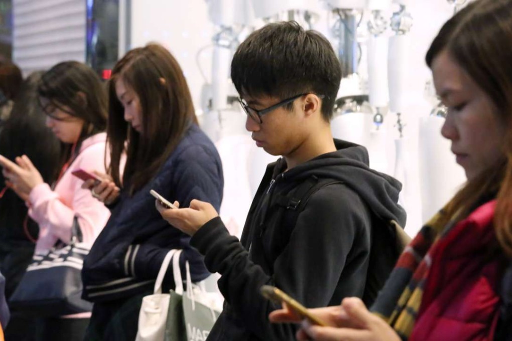 These mobile phone users may balk at accepting numbers starting with four. Photo: Nora Tam