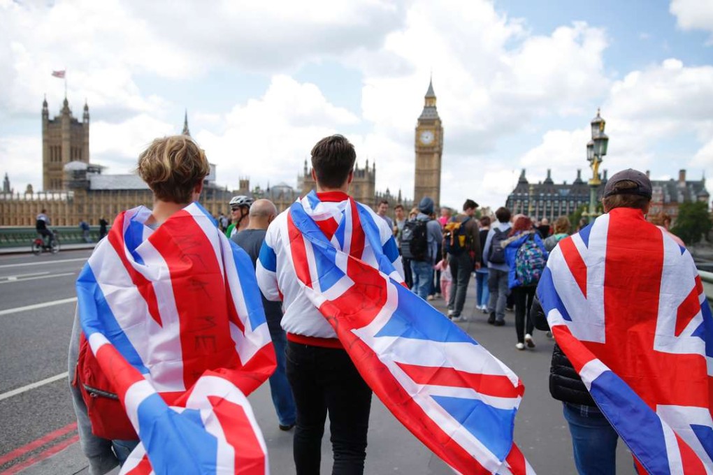 People walk over Westminster Bridge wrapped in Union flags. Photo: AFP