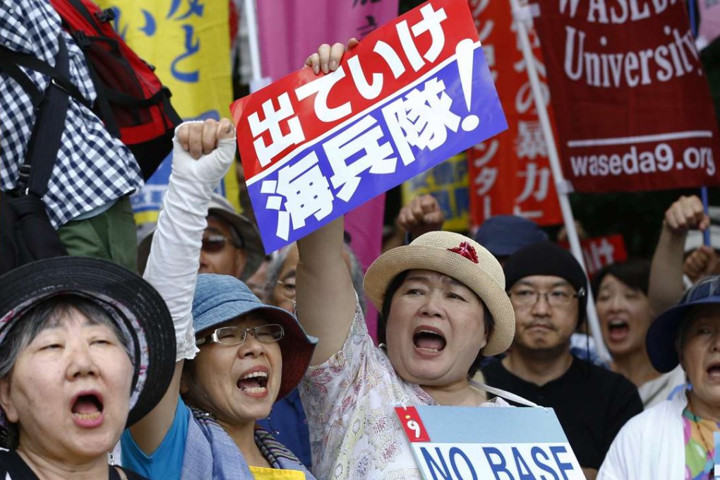 Anti-US base protesters shout slogans at a rally in front of the National Diet building in Tokyo. Photo: AP