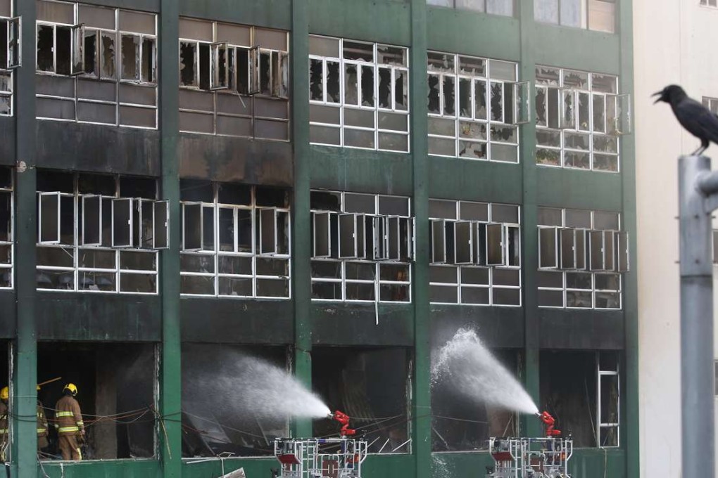 The firefighters have had to knock down each individual door of about 200 cubicles, separated by metal sheets, to inspect what was stored inside. Photo: Sam Tsang
