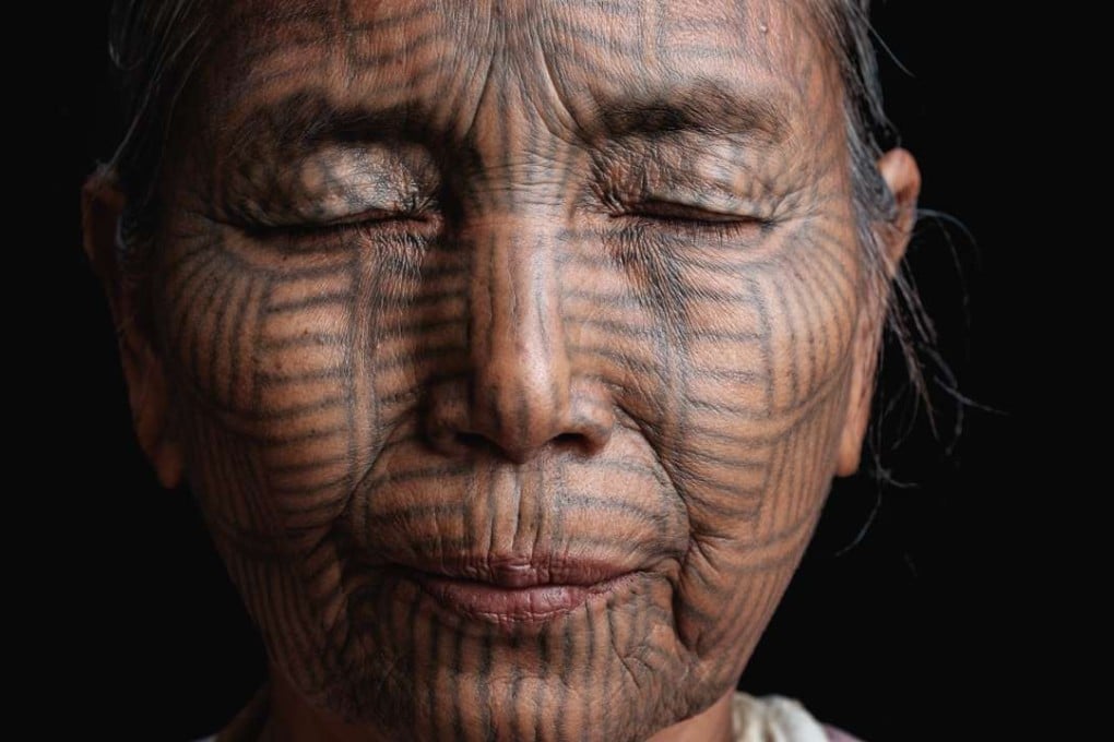Bant Tone was nine years old when she was tattooed, and clearly remembers the pain of the day. She thought she was exceptionally pretty after she got her tattoo, and was pleased that she was now considered a woman. She also felt pride, as the other peoples of Myanmar were envious of her tribe’s tattooed faces. Photos: Dylan Goldby