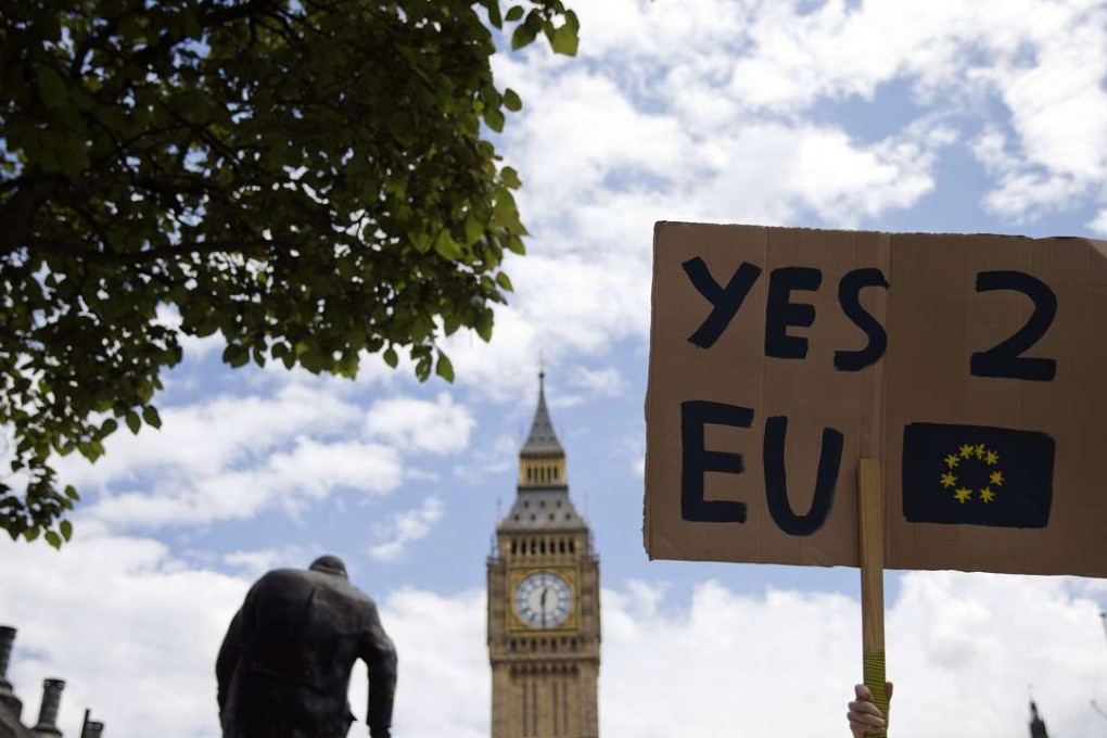 A demonstrator holds a placard during a protest against the outcome of the UK's June 23 referendum on the European Union. Photo: AFP