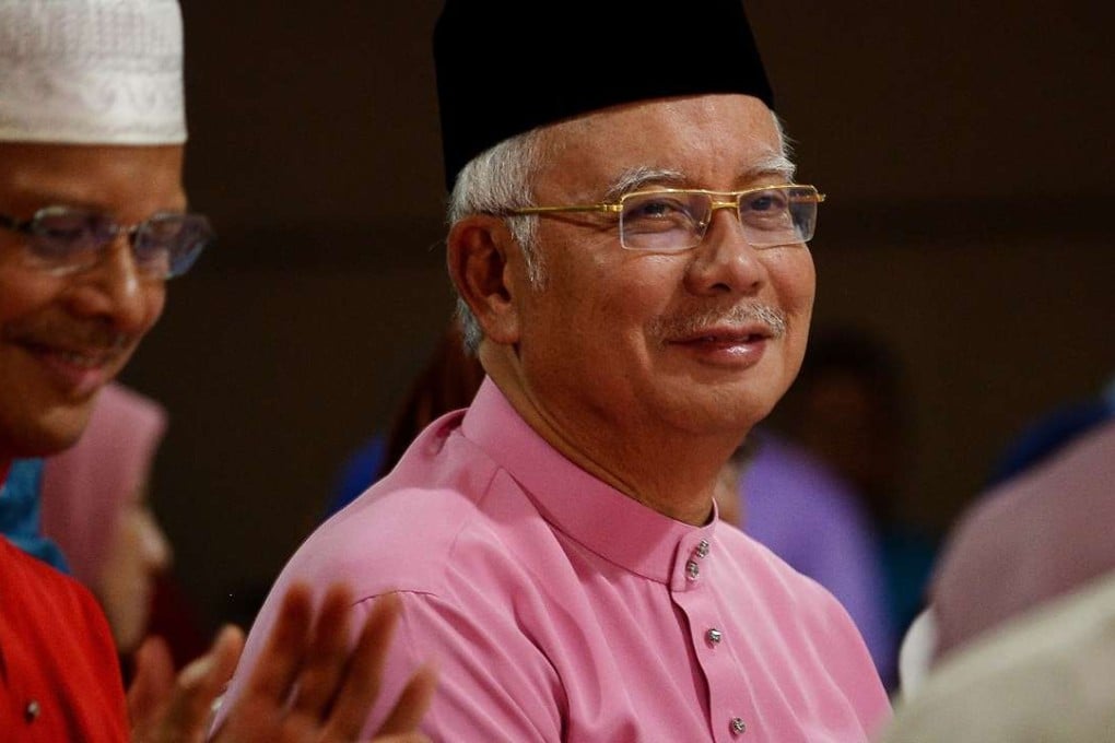 Najib Razak (right) looks on during a Ramadan event at the Putra mosque in Putrajaya. Photo: AFP