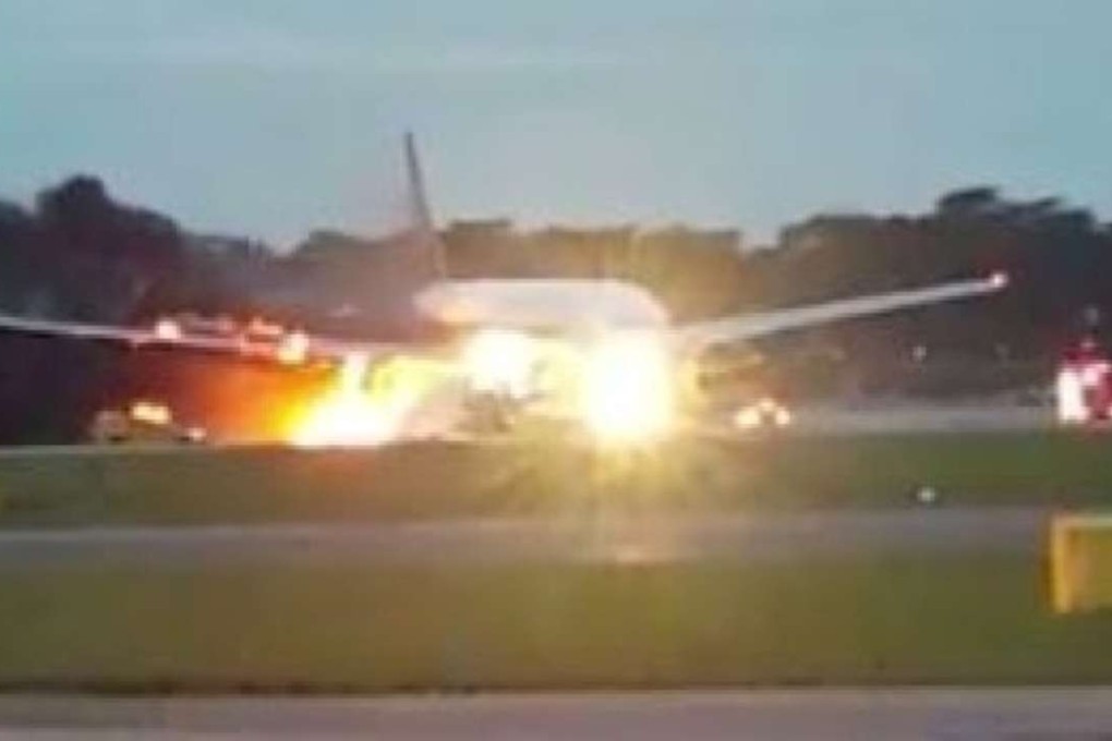 Flames and smoke erupt from the engines of a Singapore Airlines plane on the tarmac at Changi Airport on Monday. Photo: Twitter / aDilaLovatics