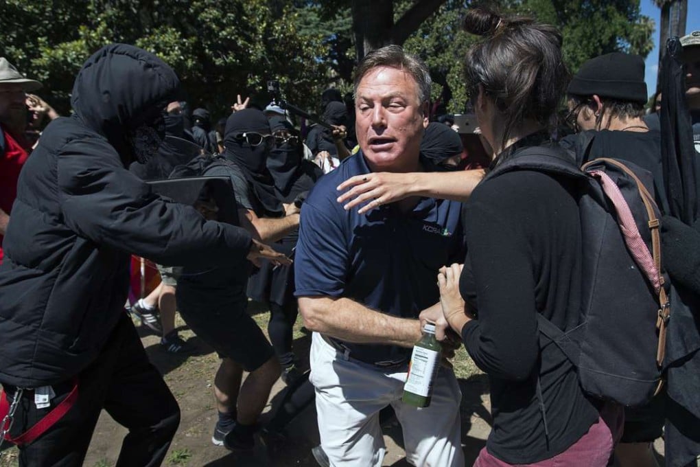 KCRA television reporter Mike Luery runs away from members of the group Anti-Fascism Action, who staged a counter-protest against the Traditionalist Worker Party and the Golden State Skinheads, at the California state Capitol in Sacramento on Sunday. Photo: AP