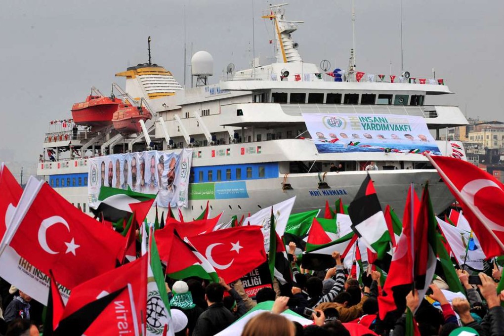 Pro-Palestinian activists wave Turkish and Palestinian flags during the welcoming ceremony for cruise liner Mavi Marmara in Istanbul on December 26, 2010. The ship was the scene of a bloody incident in May that year when Israeli navy commandos killed 10 Turkish pro-Palestinian activists who were trying to sail to the blockaded Gaza Strip. Photo: Reuters