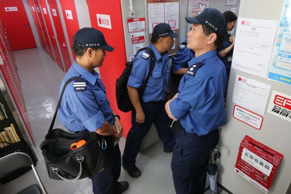 Officers check fire protection systems at a mini-storage facility in Tai Kok Tsui. Photo: Felix Wong