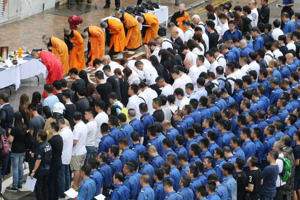 Firefighters turned up in their blue uniforms to mourn their colleague. Photo: Felix Wong