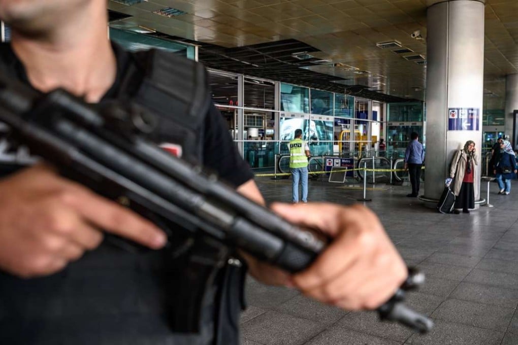 A Turkish anti-riot police officer stands guard at Ataturk airport’s international arrival terminal in Istanbul, a day after a suicide bombing and gun attack killed at least 41 people. Photo: AFP