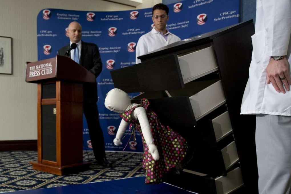 US Consumer Product Safety Commission (CPSC) Chairman Elliot Kaye, left, watches a demonstration of how an Ikea dresser can tip and fall on a child during a news conference at the National Press Club in Washington on Tuesday. Photo: AP