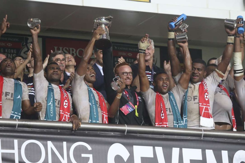 Fiji's players including captain Osea Kolinisau and coach Ben Ryan holding the trophy as they celebrate the Cup final win during the Cathay Pacific/HSBC Hong Kong Sevens 2016. Photos: SCMP