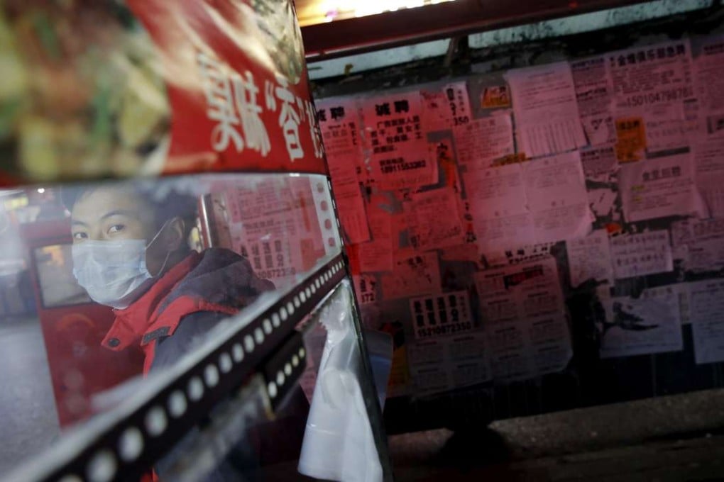 A street food vendor stands in front of a board with job notices in Beijing. A whole generation of Chinese youth raised in a miracle economy is entering a period of uncertainty as jobs come less easily. Photo: Reuters