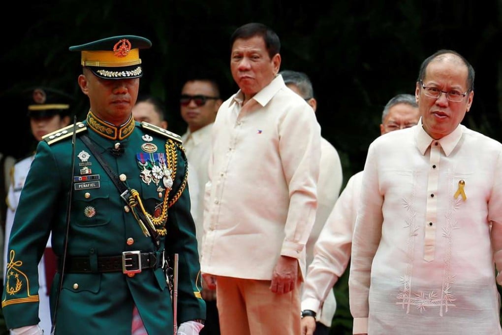 Incoming President Rodrigo Duterte looks at outgoing President Benigno Aquino during departure honours for Aquino before he leaves the Malacanang Palace in Manila. Photo: Reuters