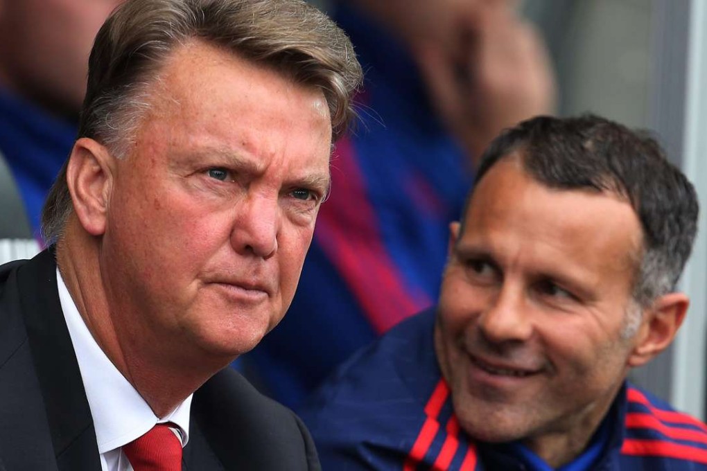 Manchester Uniteds Dutch manager Louis van Gaal sits in the dugout with assistant manager Ryan Giggs. Photo: EPA