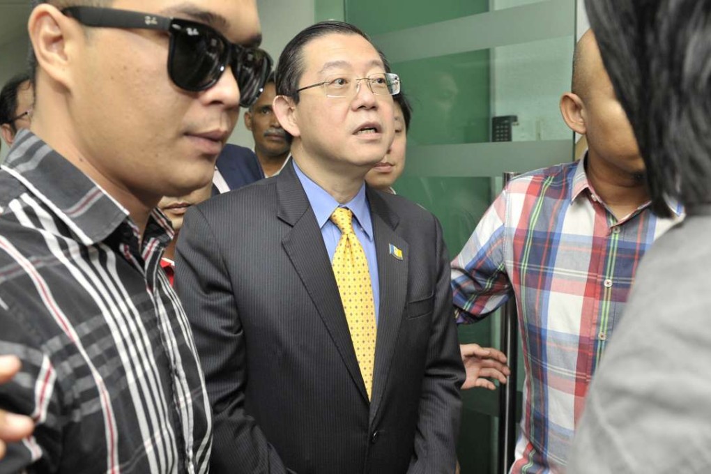 Lim Guan Eng (centre) being taken from his office in Penang by the Malaysian Anti-Corruption Commission. Photo: AP