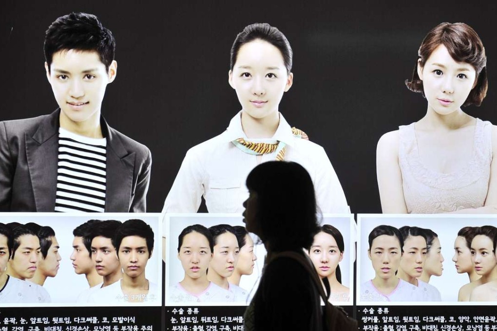 A woman walks past a street billboard advertising double-jaw surgery at a subway station in Seoul. A Korean television drama, streamed in China, has helped drive revenue for Korean cosmetic surgeons. Photo: Jung Yeon-Je, AFP