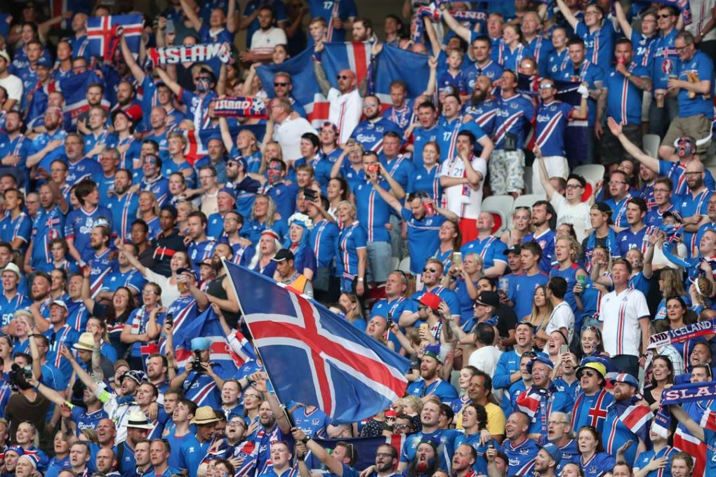 Iceland's fans cheer during the Euro 2016 round of 16 soccer match between England and Iceland. (AP Photo/Thanassis Stavrakis)