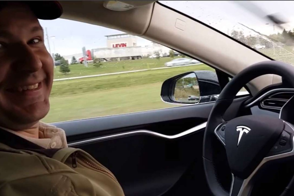 A still image from a YouTube video showing Joshua Brown in the driver's seat of his Tesla Model S with no hands on the steering wheel while he demonstrates the car's self-driving mode. Photo: AP