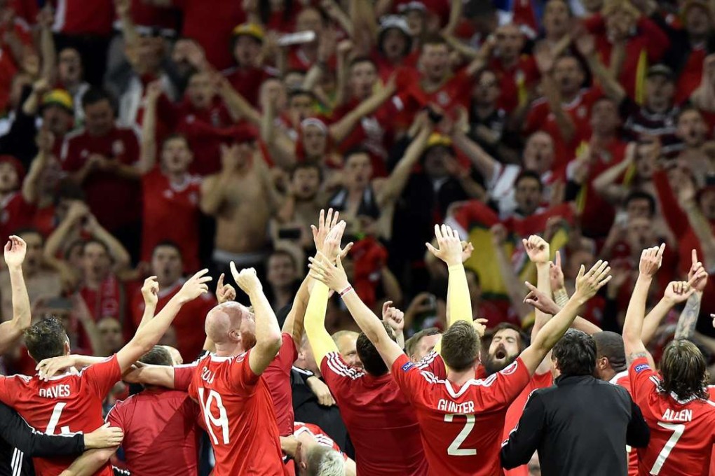 Wales celebrate with fans after the 3-1 win over Belgium. Photo: EPA