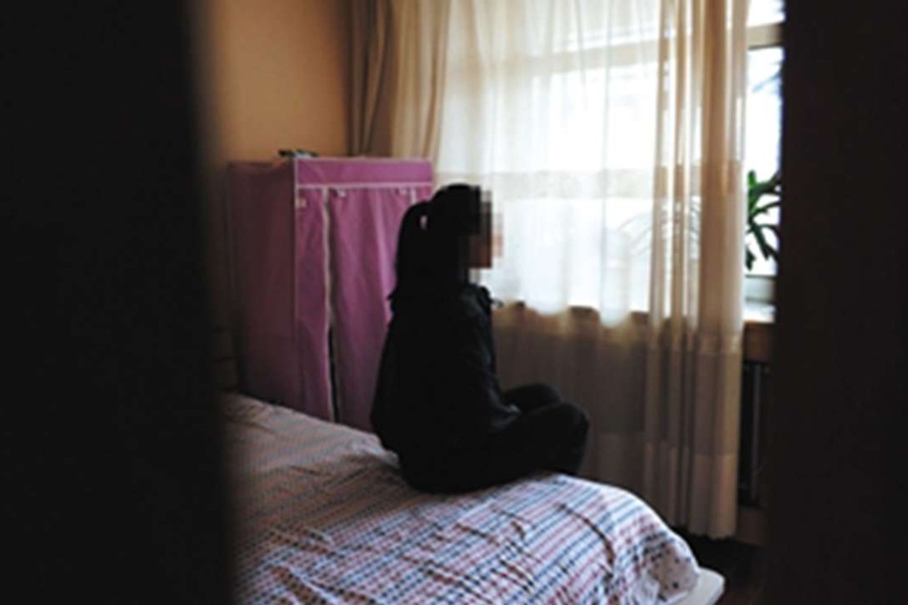 One of the victims being forced into prostitution in Manzhouli, Inner Mongolia, sitting in her bedroom. Photo: The Beijing News