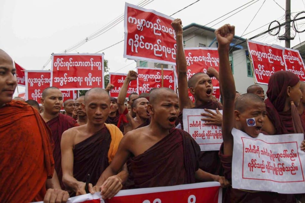 Rakhine Buddhist monks hold posters and placards as they take part in a protest against the use of the phrase ‘Muslim community in Rakhine state’ in Sittwe of Rakhine state, western Myanmar, July 3, 2016. Photo: EPA