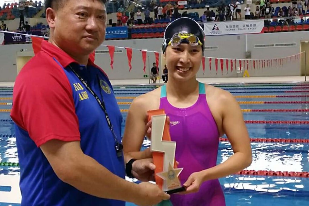 Claudia Lau is presented with the trophy for breaking the women’s 200 metre backstroke Hong Kong record at the Division One Age Group Championships at the Sports Institute. Photo: SCMP Pictures