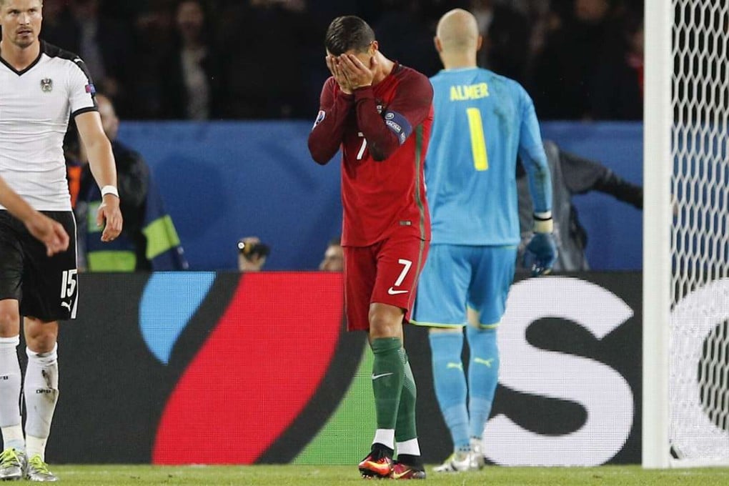 Portugal's Cristiano Ronaldo (centre) covers his face after missing a penalty during his nation’s draw in a group match with Austria at Euro 2016. Photo: AP