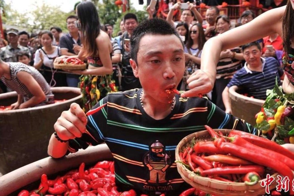 The winner of the competition is fed a chilli during Saturday’s contest. Photo: China News Service