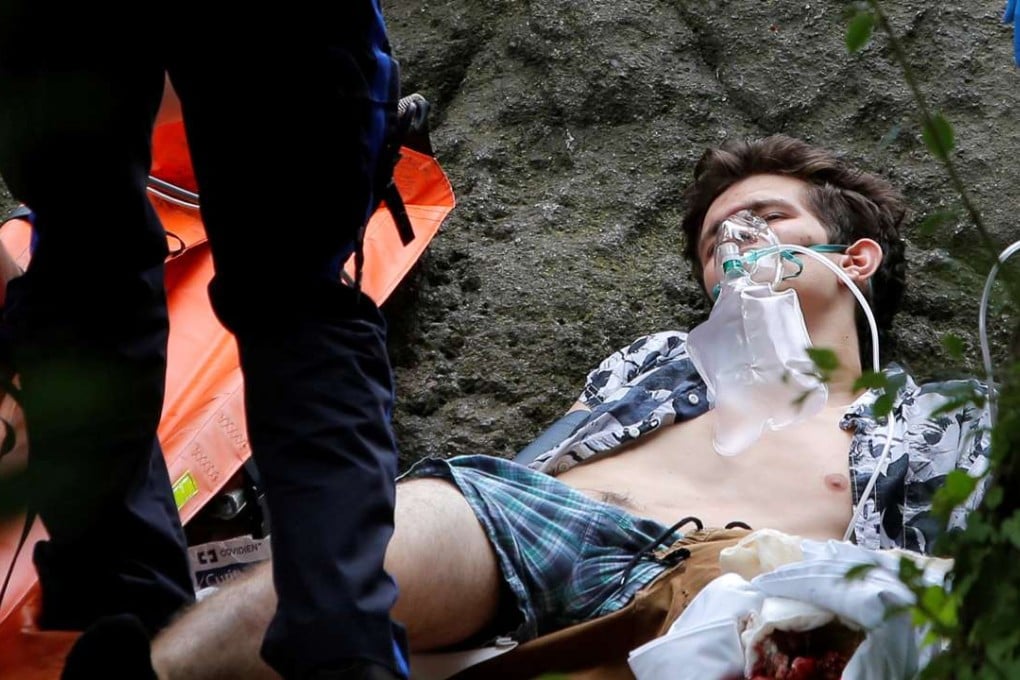 Medics stand over a man whose left foot was mangled in an explosion in Central Park in New York on Sunday. Photo: Reuters