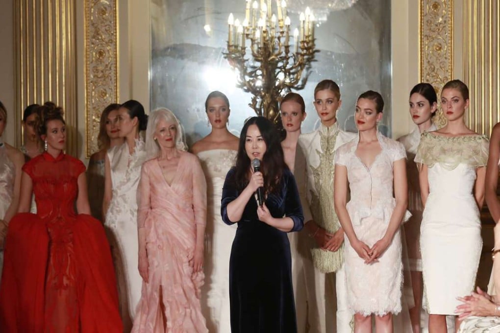 Flanked by models wearing her creations, Grace Chen speaks during an exclusive fashion show at London’s Lancaster House. Photo: Anton Phatianov