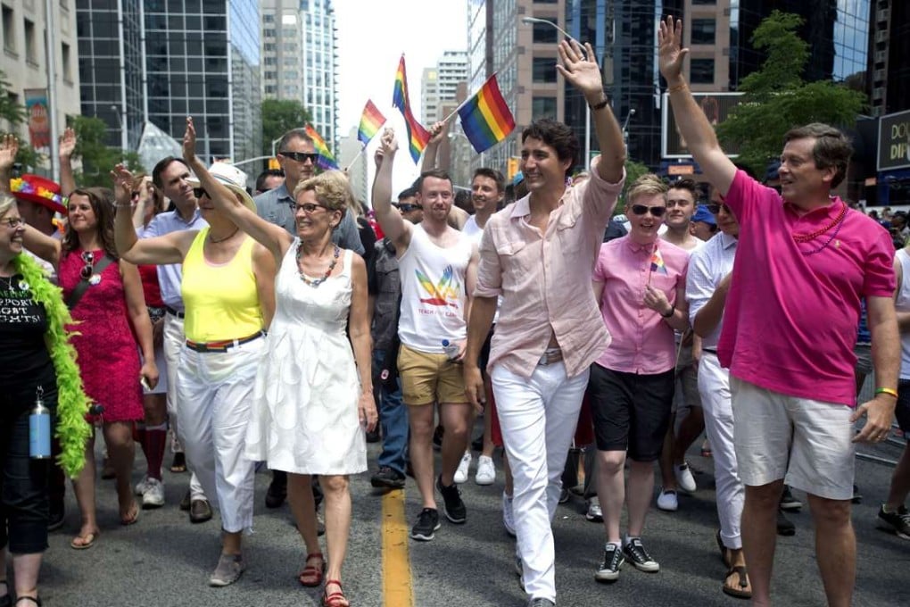 Green Party Leader Elizabeth May (front, left to right), Ontario Premier Kathleen Wynne, Prime Minister Justin Trudeau and Toronto Mayor John Tory wave to spectators at the annual Pride Parade in Toronto on Sunday. Photo: AP