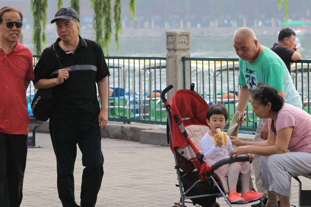 An elderly couple pictured taking care of their granddaughter in Beihai park in Beijing. Photo: Simon Song