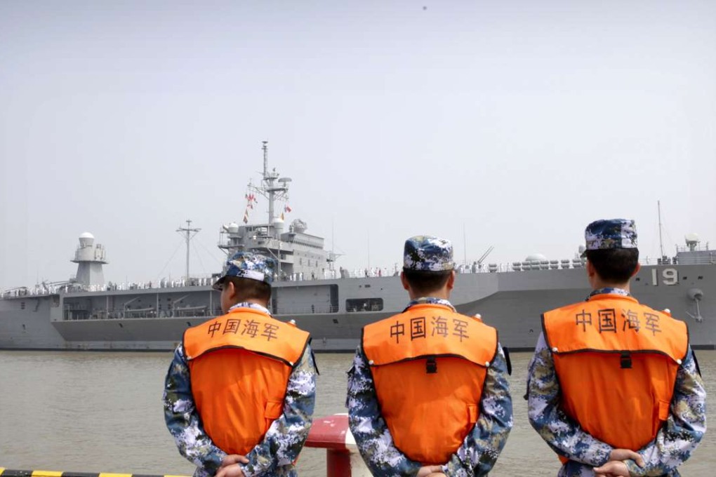 In this May 6 file photo, soldiers from the People's Liberation Army Navy watch as the USS Blue Ridge arrive at a port in Shanghai. Photo: AP