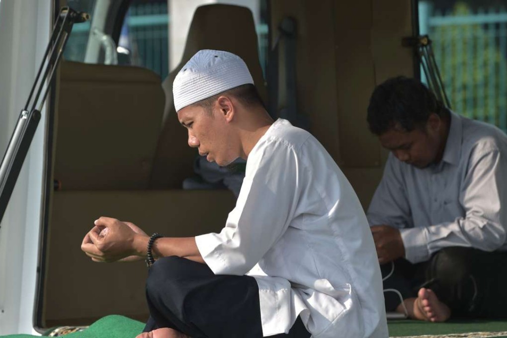 Indonesian men offering prayers at a "mobile mosque" outside a sports complex in Jakarta. Photo: AFP