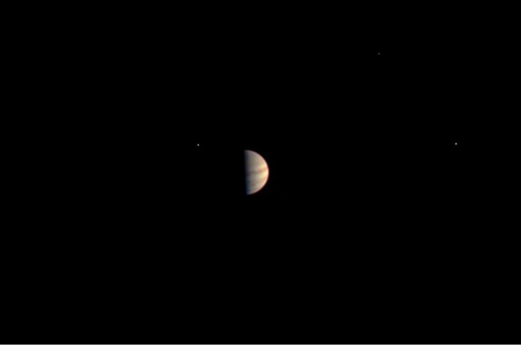 This photo provided by Nasa on Monday was snapped by the Juno spacecraft some 2.8 billion kilometres from Earth, as it made its approach to Jupiter last Friday. Four of the planet’s moons can also be seen glinting very faintly: Ganymede (bottom left), Io (centre, next to Jupiter), Callisto (top right) and Europa (right). Photo: AFP