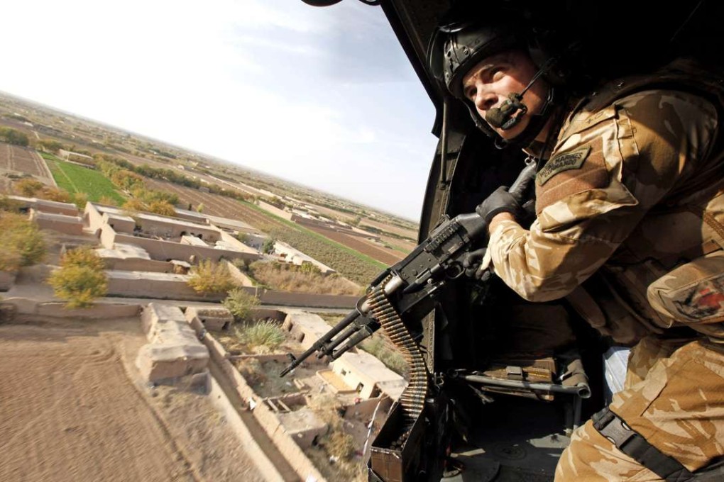 A British gunner in Helmand Province, Afghanistan. Photo: Heathcliff O'Malley / Rex Features