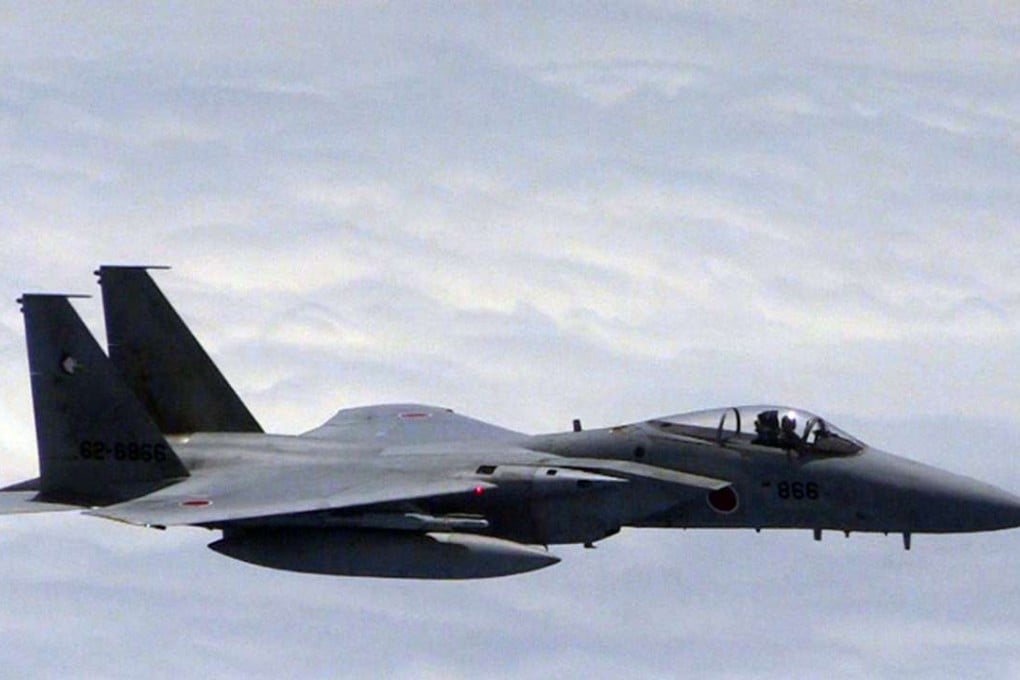 A Japanese F-15 jet approaches a Chinese plane (out of frame) in 2014 in a spot where the two countries' air defence zones overlap. Photo: AFP