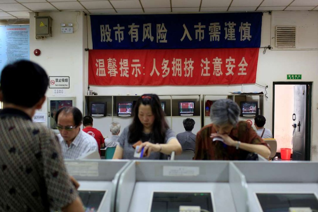 Investors look at computer screens showing stock information at a brokerage house in Shanghai on June 23, 2016. Photo: Reuters